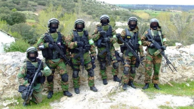 People in military uniforms with weapons