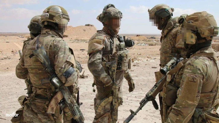 A group of armed men in camouflage without chevrons