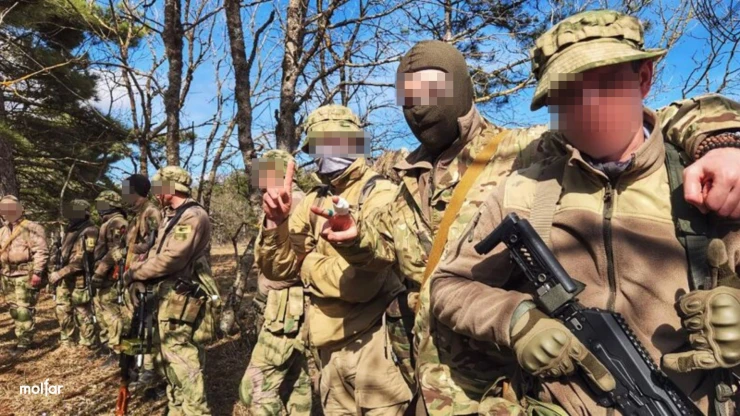 Group of armed men in camouflage