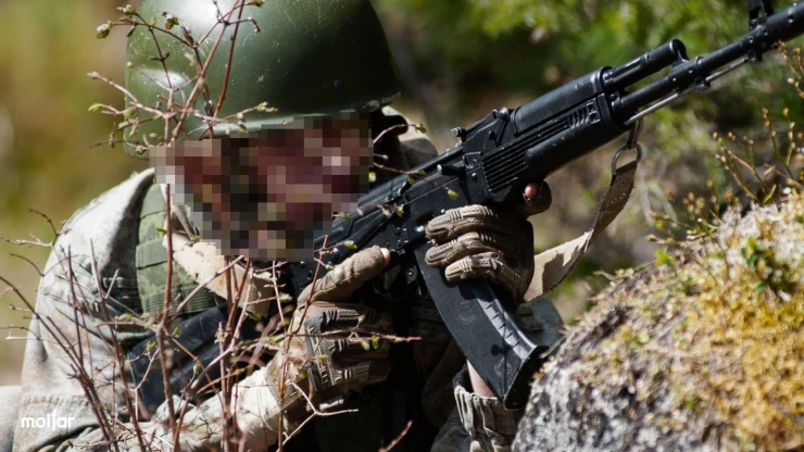 Man in camouflage with a machine gun