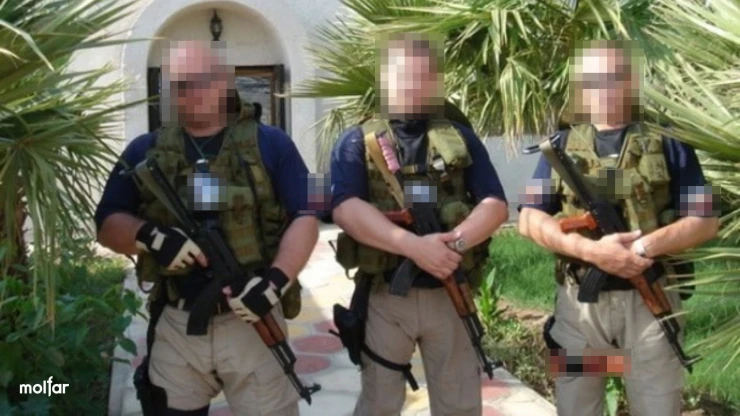 Three men with machine guns