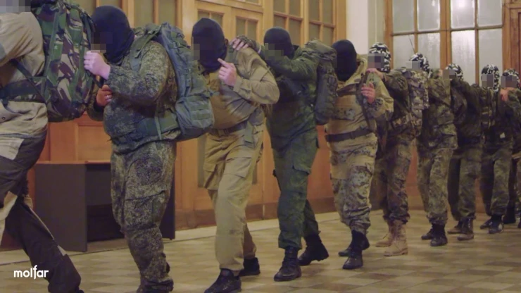 Group of people in balaclavas and camouflage