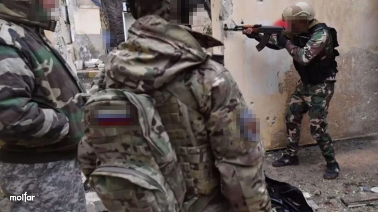 People in camouflage inside a building